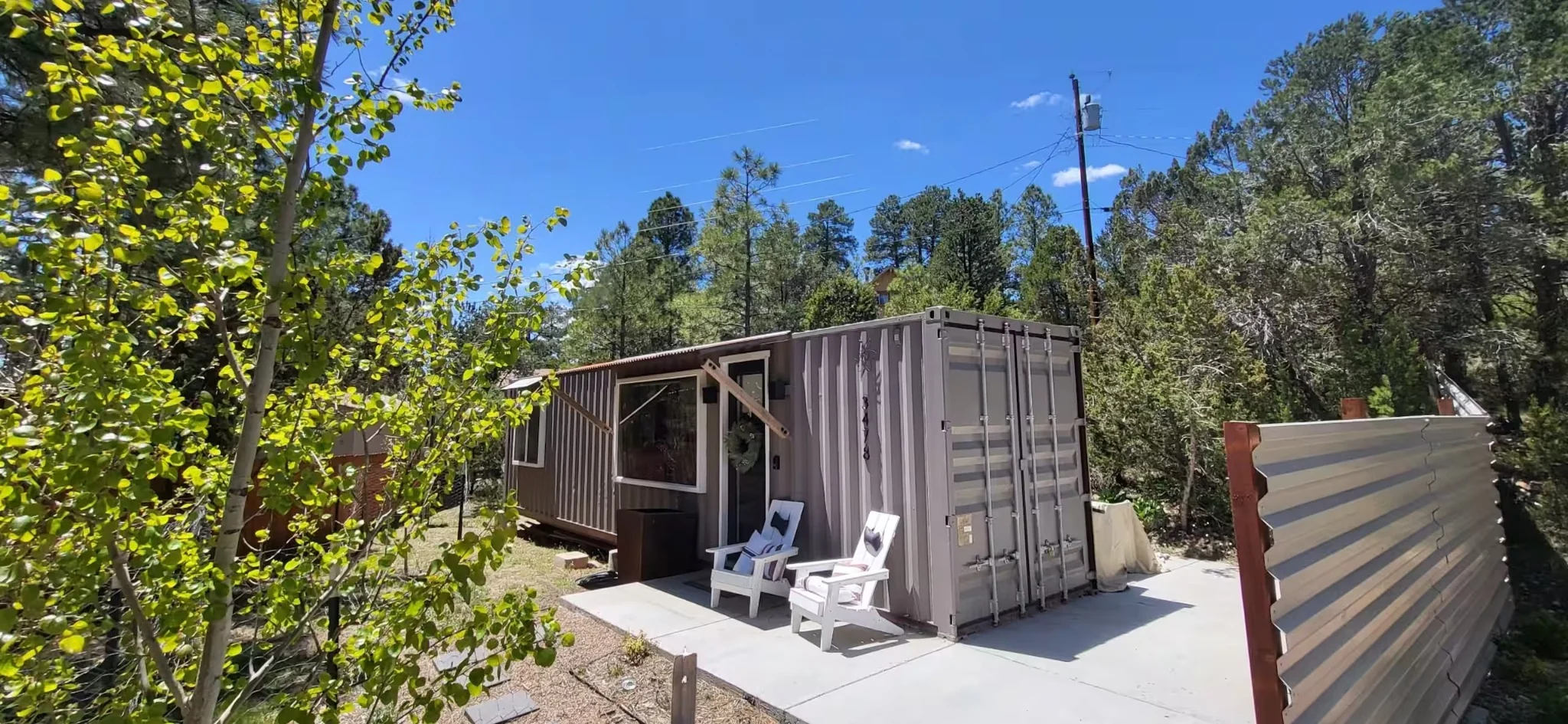 ATOM shipping container house among pine trees